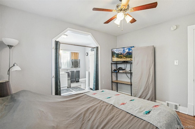 bedroom with ceiling fan, hardwood / wood-style flooring, and connected bathroom