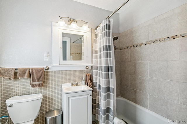 full bathroom with vanity, toilet, tile walls, and shower / bath combo