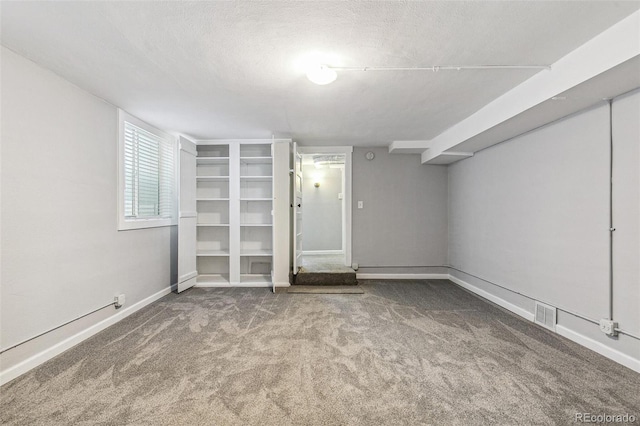 unfurnished bedroom with a textured ceiling and carpet