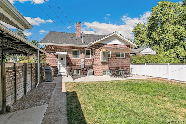 back of house featuring a yard and a patio area