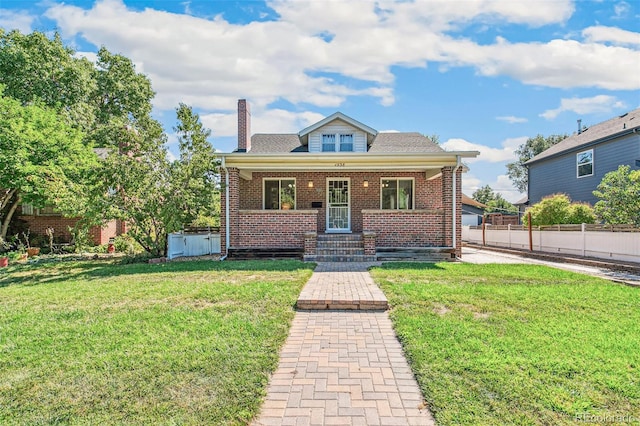 bungalow-style house with a front yard and a porch