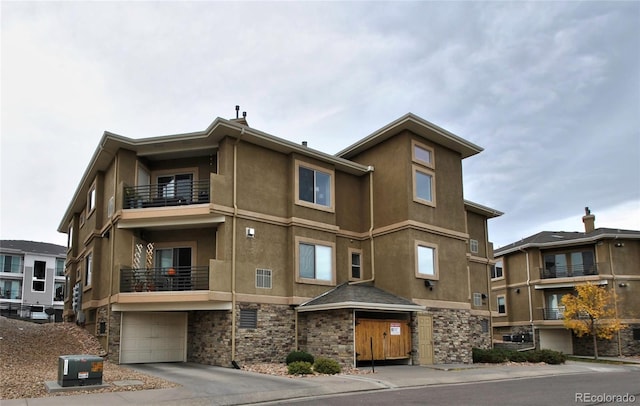 view of building exterior featuring a garage and central AC