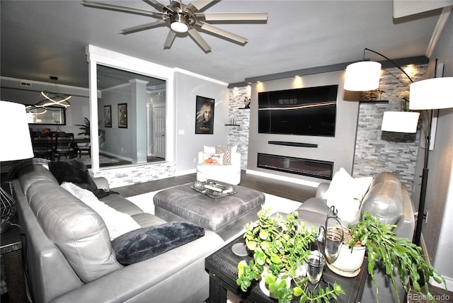 living room featuring hardwood / wood-style floors, crown molding, and ceiling fan