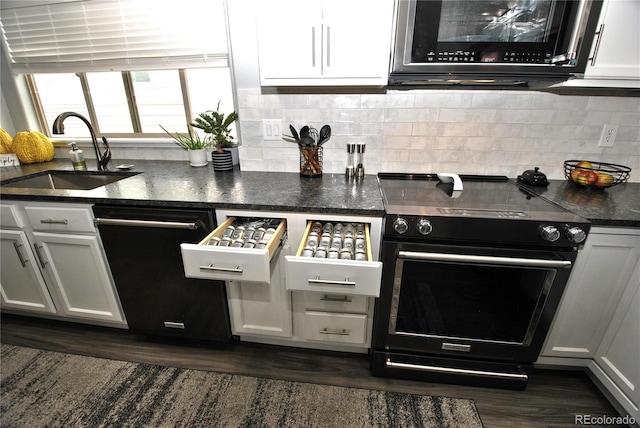 kitchen featuring white cabinetry, sink, decorative backsplash, and black appliances