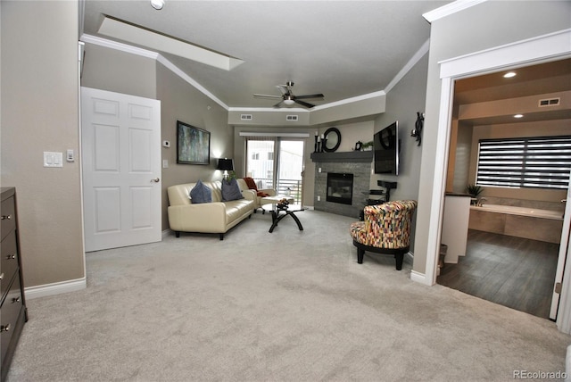 living room with ornamental molding, light colored carpet, and ceiling fan