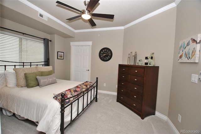 carpeted bedroom with ornamental molding and ceiling fan