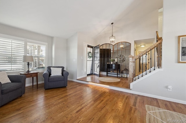 entrance foyer with hardwood / wood-style flooring and a notable chandelier