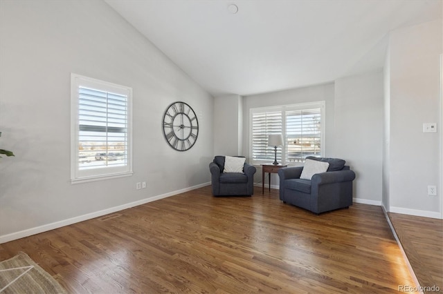 living area featuring dark hardwood / wood-style flooring and lofted ceiling