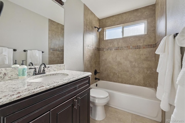 full bathroom featuring vanity, tiled shower / bath combo, toilet, and tile patterned flooring