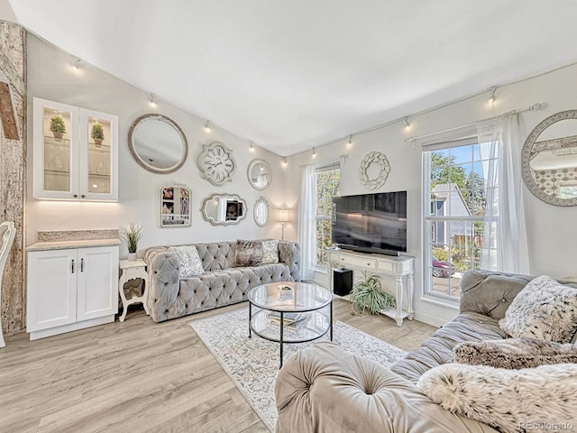 living room with vaulted ceiling and light hardwood / wood-style flooring