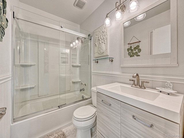 full bathroom featuring tile patterned flooring, vanity, bath / shower combo with glass door, and toilet