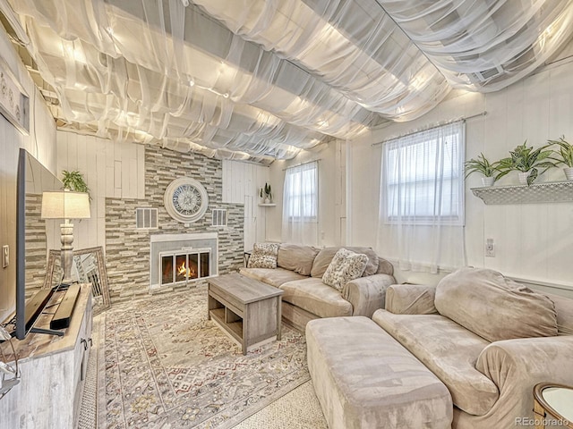 living room with a stone fireplace