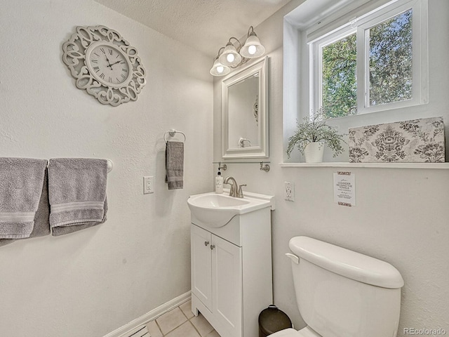 bathroom featuring tile patterned floors, vanity, a textured ceiling, and toilet