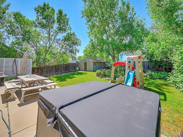 view of patio / terrace featuring a storage unit and a hot tub