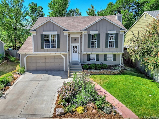 split foyer home with a garage and a front lawn