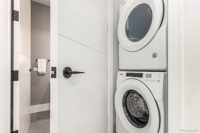 clothes washing area featuring stacked washer / dryer and tile patterned floors