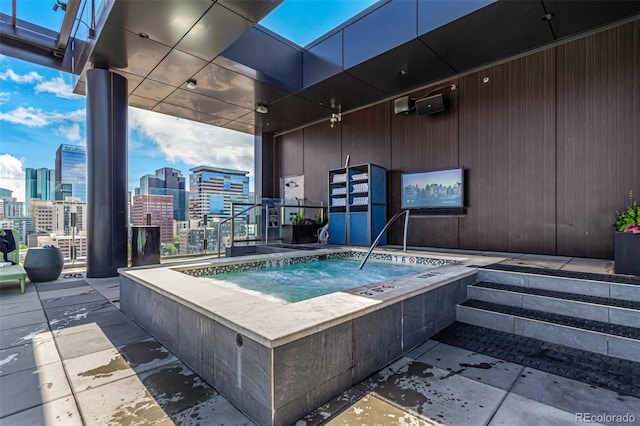 view of pool with a hot tub