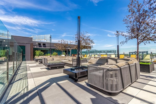 view of patio / terrace with an outdoor living space with a fire pit