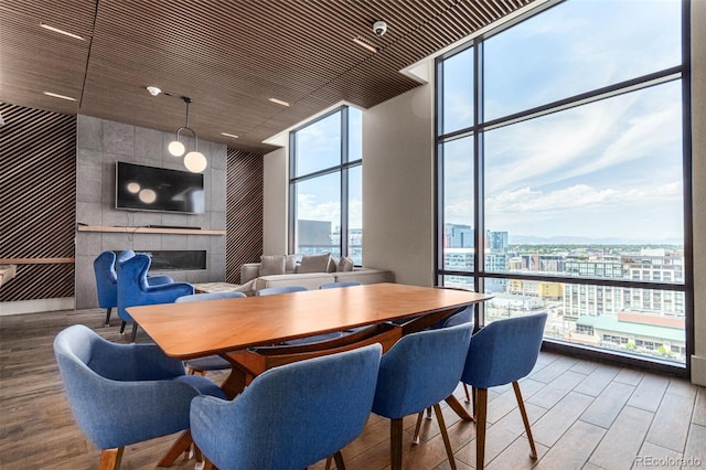 dining space with a fireplace, hardwood / wood-style flooring, and floor to ceiling windows