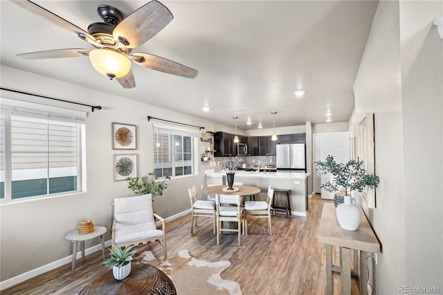 living room with wood-type flooring, plenty of natural light, and ceiling fan