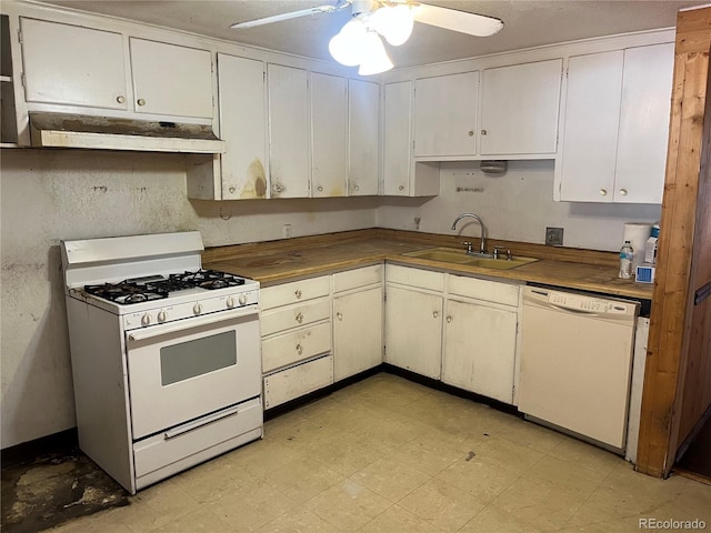 kitchen featuring white appliances, ceiling fan, white cabinetry, and sink