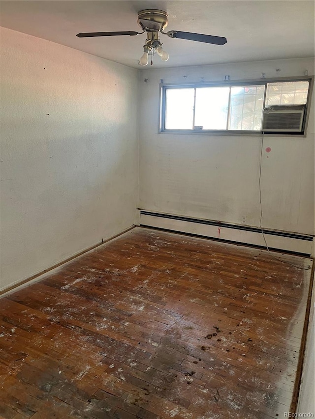 empty room featuring a baseboard heating unit and ceiling fan