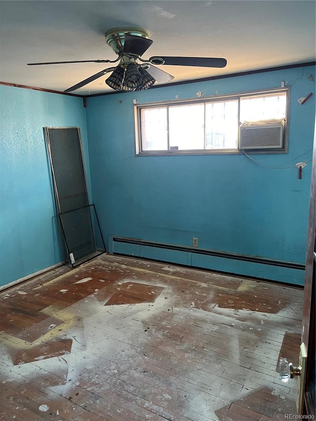 spare room with ceiling fan, a baseboard radiator, and a wealth of natural light