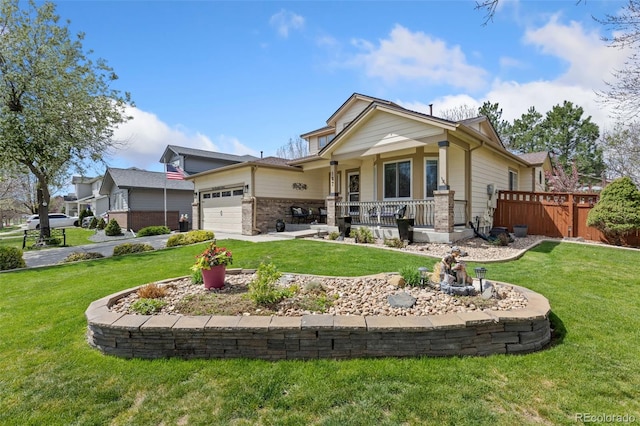 view of front of home featuring a porch, a garage, fence, a front lawn, and concrete driveway