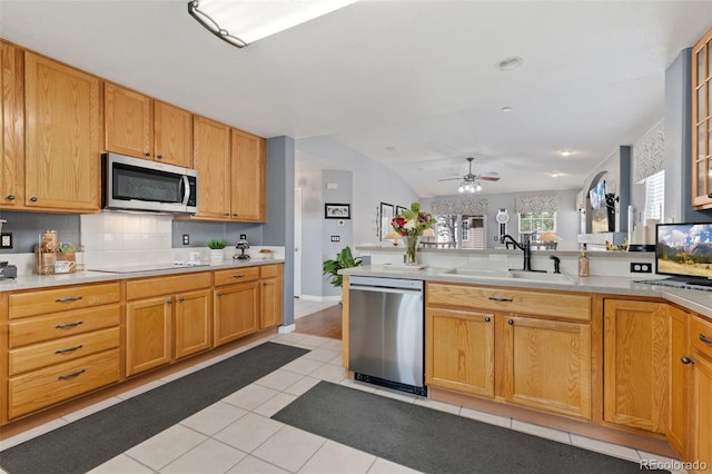 kitchen featuring light countertops, a sink, a ceiling fan, and stainless steel appliances