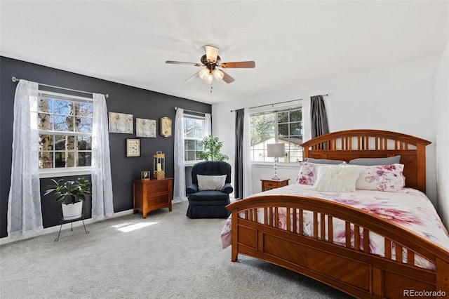 carpeted bedroom featuring baseboards and ceiling fan