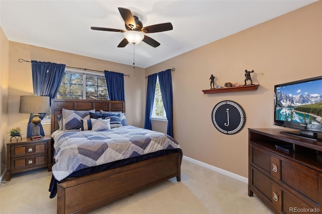 bedroom featuring baseboards, light carpet, and a ceiling fan