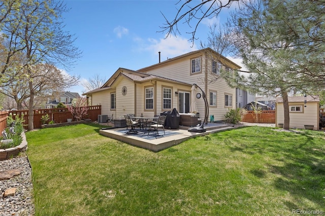 back of property featuring a lawn, a fenced backyard, central air condition unit, and an outbuilding