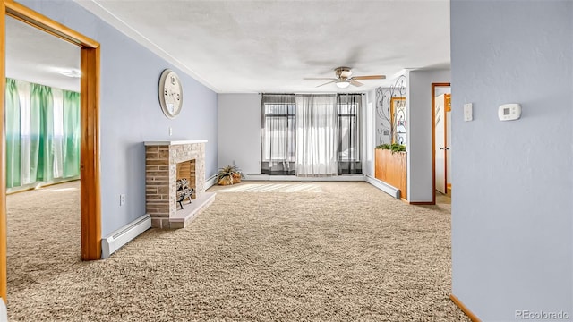 unfurnished living room featuring ceiling fan, carpet, and a baseboard heating unit