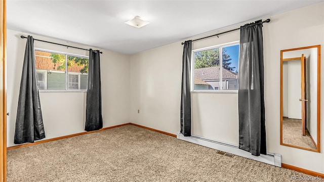 spare room featuring carpet flooring and a healthy amount of sunlight