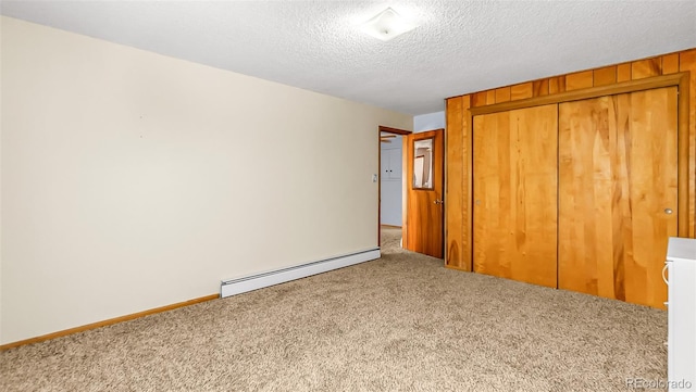 unfurnished bedroom with a baseboard radiator, a closet, carpet floors, and a textured ceiling