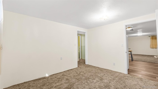 spare room featuring light colored carpet