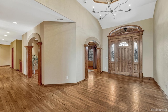 14581 E Oberlin Pl, Aurora, CO 80014 - entrance foyer with arched walkways, wood finished floors, baseboards, recessed lighting, and a chandelier