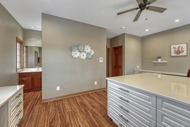 14581 E Oberlin Pl, Aurora, CO 80014 - kitchen featuring a ceiling fan, light countertops, baseboards, dark wood-type flooring, and a sink