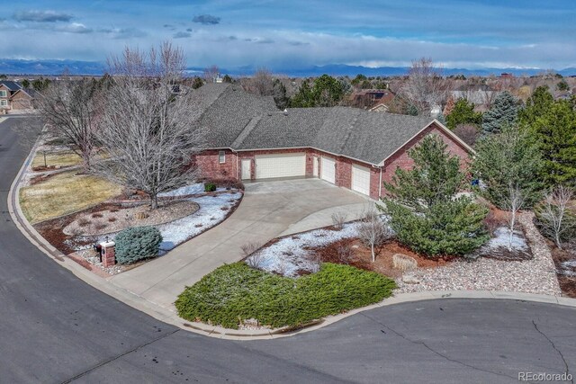 14581 E Oberlin Pl, Aurora, CO 80014 - view of front of property featuring driveway, brick siding, and an attached garage