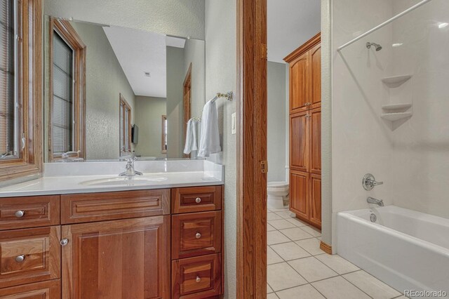 14581 E Oberlin Pl, Aurora, CO 80014 - bathroom with tile patterned floors, vanity, toilet,  shower combination, and a textured wall