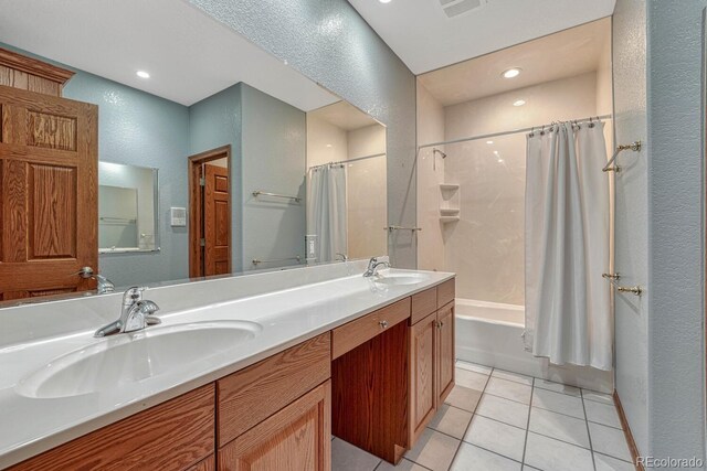 14581 E Oberlin Pl, Aurora, CO 80014 - full bath featuring a textured wall, shower / bath combo, double vanity, tile patterned flooring, and recessed lighting