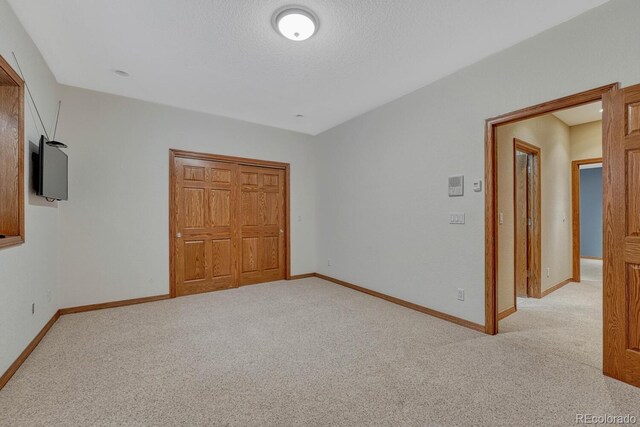14581 E Oberlin Pl, Aurora, CO 80014 - unfurnished bedroom with carpet, baseboards, a closet, and a textured ceiling
