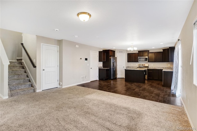 10733 Calista Way, Fountain, CO 80817 - kitchen featuring stainless steel appliances, a chandelier, dark colored carpet, dark brown cabinetry, and a kitchen island
