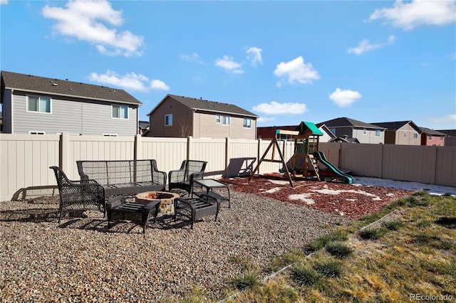 10733 Calista Way, Fountain, CO 80817 - fenced backyard featuring a residential view, a playground, and an outdoor living space with a fire pit