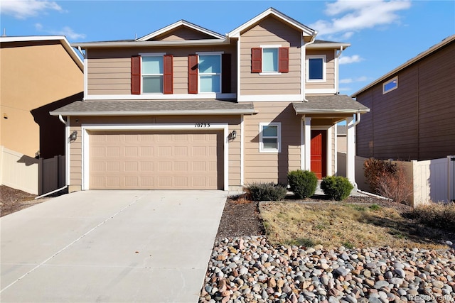 10733 Calista Way, Fountain, CO 80817 - view of front of property featuring an attached garage, driveway, fence, and a shingled roof