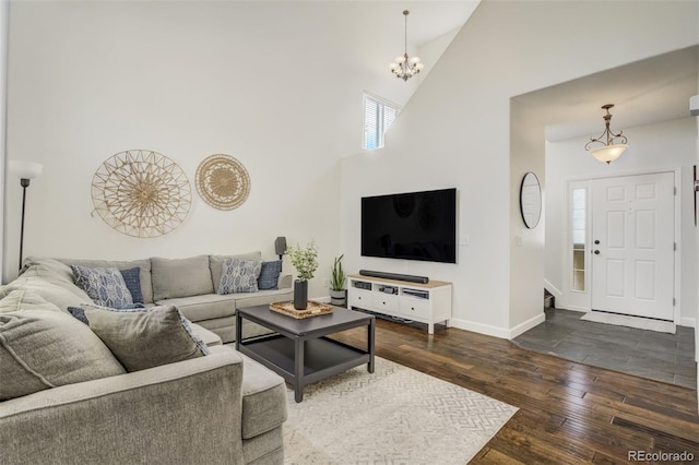 9643 Yukon Way, Colorado Springs, CO 80925 - living room with hardwood / wood-style floors, baseboards, high vaulted ceiling, and a chandelier