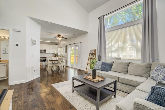 9643 Yukon Way, Colorado Springs, CO 80925 - living area featuring dark wood-style floors, a ceiling fan, baseboards, and high vaulted ceiling