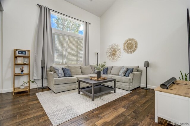 9643 Yukon Way, Colorado Springs, CO 80925 - living area featuring dark wood-style flooring, lofted ceiling, and baseboards