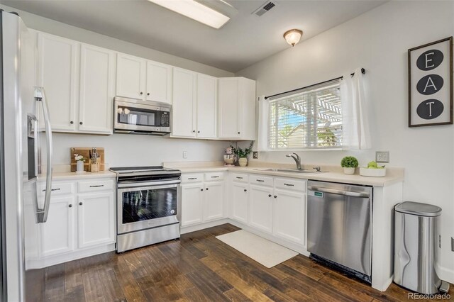 9643 Yukon Way, Colorado Springs, CO 80925 - kitchen featuring stainless steel appliances, a sink, dark wood-type flooring, and white cabinetry