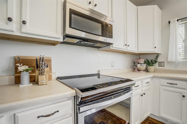 9643 Yukon Way, Colorado Springs, CO 80925 - kitchen with stainless steel appliances, white cabinets, and light countertops